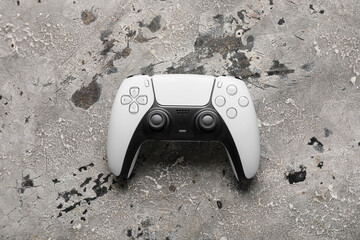 Gaming and entertainment industry, modern video game controller on textured concrete background for digital leisure and interactive media concepts © Pixel-Shot