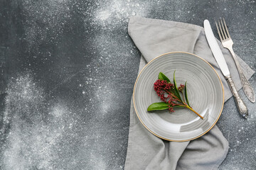 Naklejka premium Beautiful table setting with skimmia japonica plant on dark background