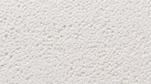 Close-up view of a white expanded polystyrene foam surface, featuring a dense, granular texture composed of numerous small, compressed spherical beads and irregular circular patterns
