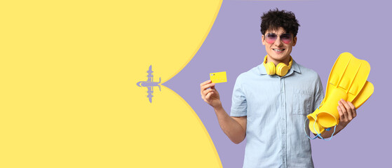 Travel planning and summer vacation concept, young man with credit card and flippers ready for holiday trip © Pixel-Shot