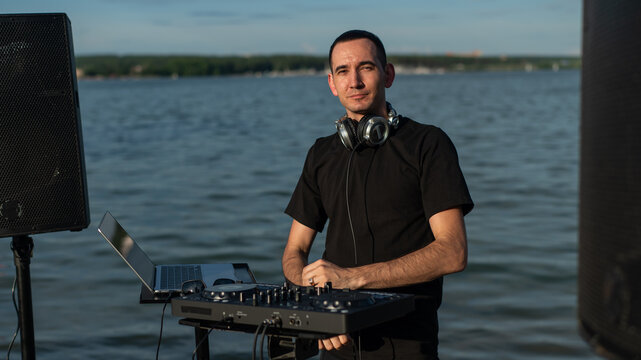 Portrait of a DJ on the river bank. 