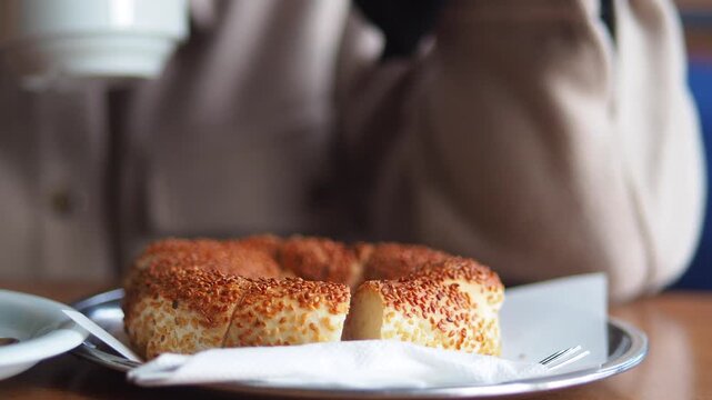 Eating sesame bagel in a cafe
