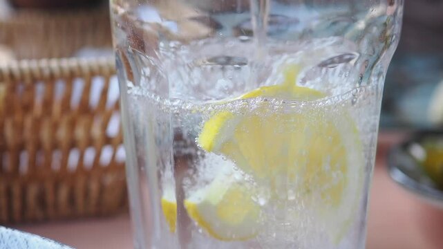Lemon slices float in glass of sparkling water