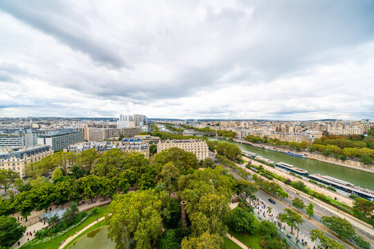 Panoramic aerial view of seine river and paris cityscape under cloudy sky in france