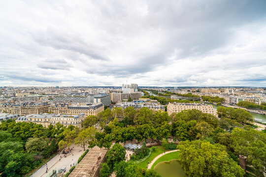 Panoramic aerial view of seine river and paris cityscape under cloudy sky in france