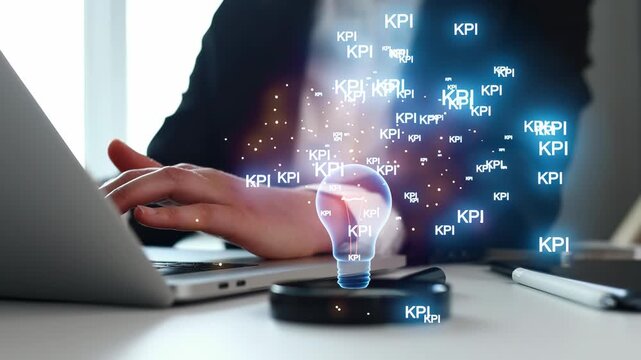 A person is using a laptop on a desk while ideas represented by light bulbs and KPI terms appear. The setting is bright and indicates a focus on work and productivity.