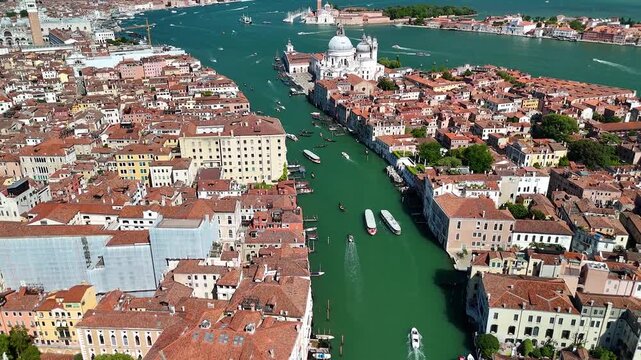 Venice, Italy. Aerial panoramic drone view of the city. Majestic sunny view of the ancient city skyline with Grand Canal, Palazzo Ducale, St Mark's square and other iconic buildings. Europe from above