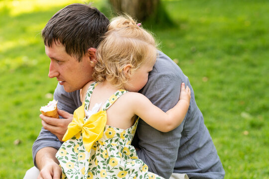 Toddler Daughter Hugging Father During Family Day Outdoors
