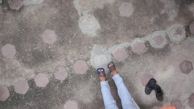 Young Person Feet in Flip Flops Moving Relaxed in Home Yard