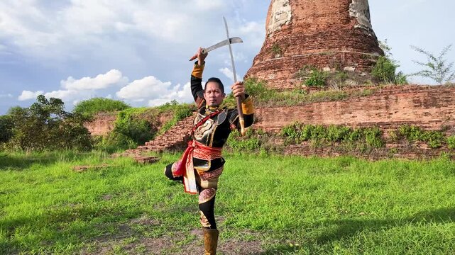 Thai Warrior in Traditional Armor Practicing Sword Skills at Ayutthaya Ruins
