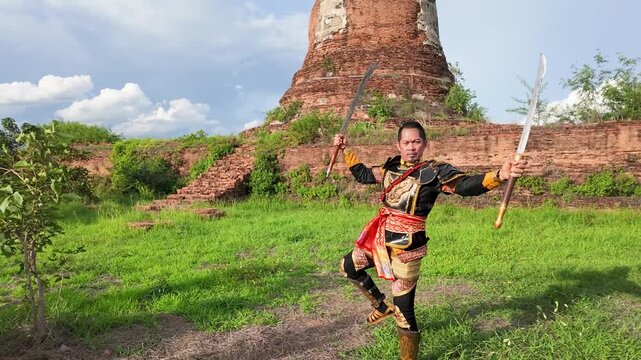 Thai Warrior in Traditional Armor Practicing Sword Skills at Ayutthaya Ruins