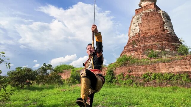 Thai Warrior in Traditional Armor Holding Sword at Ayutthaya Ruins