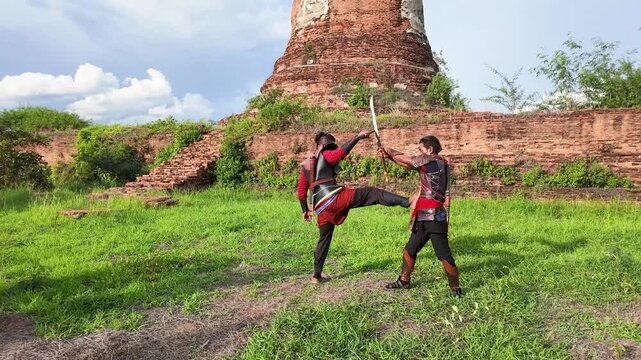 Thai Warriors Sparring with Swords at Ancient Ayutthaya Ruins