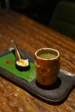 A glass of a unique cocktail "Kaprao Moo Krob Kai Dao Mai Sook (crispy pork with chili  basil and fried egg)" which is based on Thailand's food of the same name inside a bar in Bangkok, Thailand