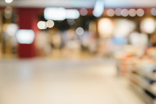 Blurred interior shopping mall background creates relaxed and peaceful atmosphere with soft light, wide perspective, and bokeh effect