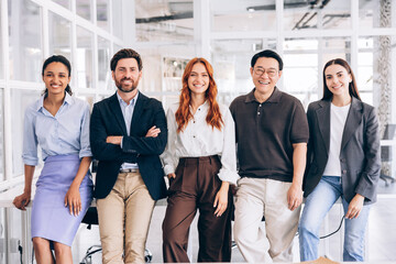 Obraz premium Diverse business team smiling standing in modern office
