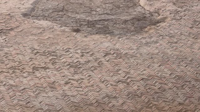 Ancient roman herringbone brick pavement moving down