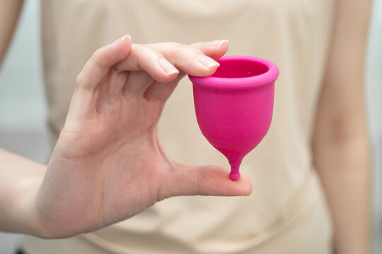 Asian woman holding menstrual cup for hygiene menstrual period cycle protection.