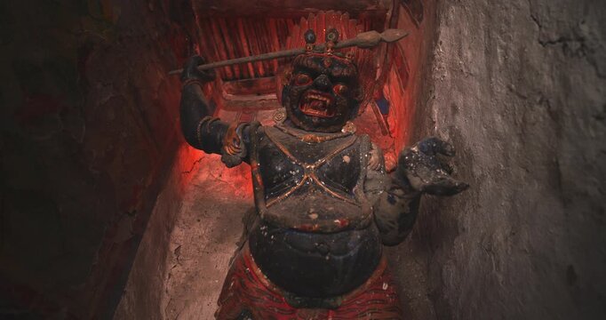 Annapurna Circuit, Manang, Nepal, medium-angle shot of an ancient clay and pigment Vajrapani protector statue inside Bhraka Monastery