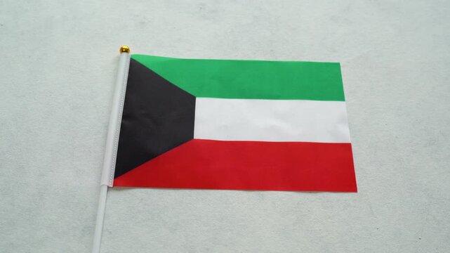 Kuwait country flag. Orbitating shot. Kuwaiti miniature flag close up.
