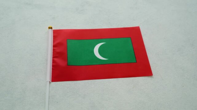 Close up shot of Maldives miniature flag. Maldivian patriotism concept.