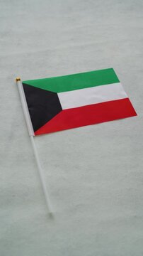 Kuwait country flag. Vertical shot. Kuwaiti flag with background.