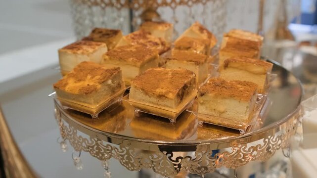 An elegantly decorated reception table displays small plates of caramel flan prepared for quinceanera guests