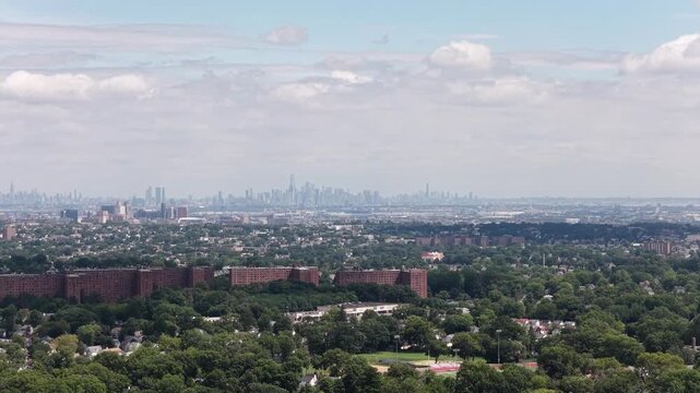 A smooth rightward pan tracks across the distant Manhattan skyline while progressively revealing the broad Maplewood and South Orange suburban landscape.