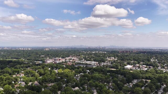 The camera pans right from the distant Manhattan skyline across leafy neighborhoods, community buildings and the broad Maplewood and South Orange horizon.