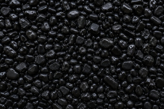 Dense black pebble stone texture and natural rock background