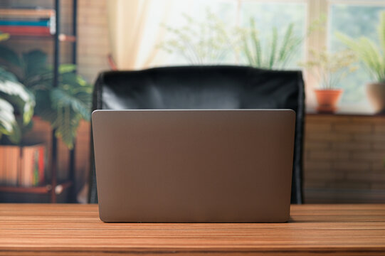 Laptop on Table with Cozy Workspace and Natural Light Background