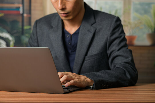 Professional Man Using Laptop in Modern Office Environment