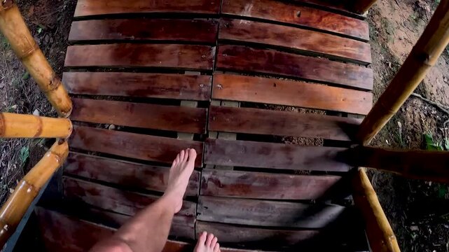 Wooden Canoe Bow on Calm Amazon River in Ecuador, Dark Planks, Bare Foot, Brown Water and Remote Tropical Rainforest Travel Perspective