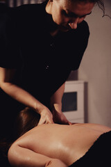 Relaxing Therapeutic Massage Session in a Dimly Lit Medical Room for Health and Rehabilitation © Aleksandr