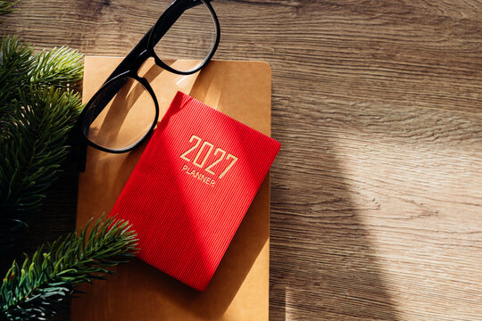 Planning new year goals for 2027 on wood desk