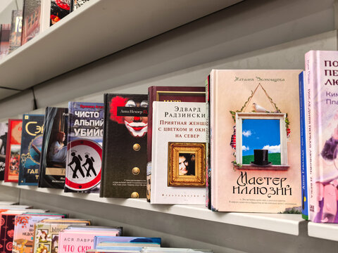 Assorted Book Spines and Covers Arranged on a Library Shelf