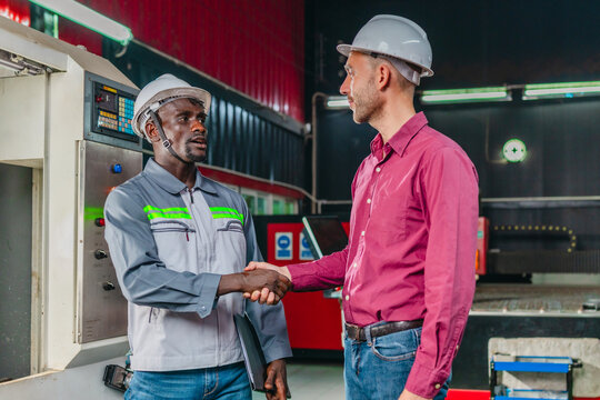 Sales Engineer and Client Negotiate Quotation Terms in Industrial Workshop