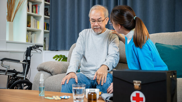 Asian nurse wearing white uniform with stethoscope visit home helping consulting older man patient explaining treatment medicine dosage plan, medicine healthcare