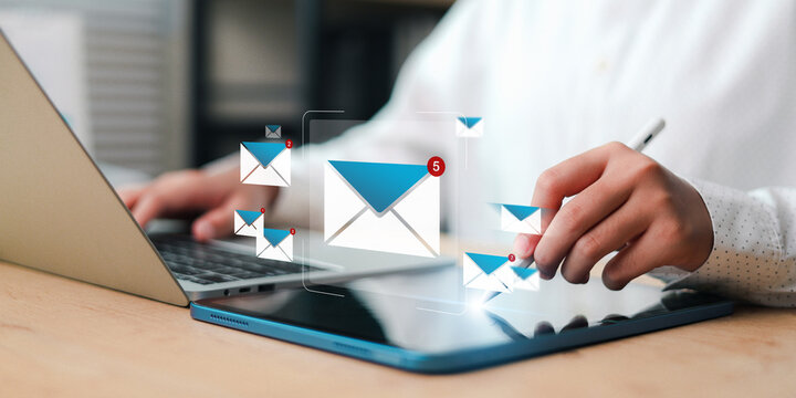 Email notification icon over laptop and tablet. Concept of business communication, inbox alert, workflow, and digital messaging.