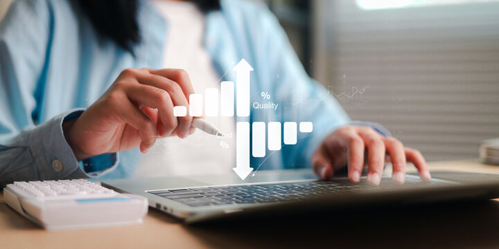 Business professional using a laptop with digital performance charts, quality metrics, cost analysis, and growth indicators, representing data analytics,