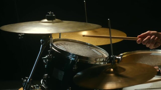 Close up drummer playing drum kit with sticks, practicing rhythm and technique. Rehearsal in studio, skill development. Drummer practicing on drum kit close up 