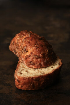 Multi Grain Bread Still Life. Two pieces of a fresh baked bread on a baking sheet with the heel on top