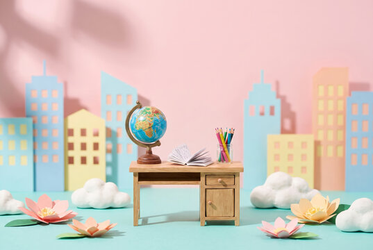 An intricate miniature diorama of a whimsical study desk inside a stylized craft room