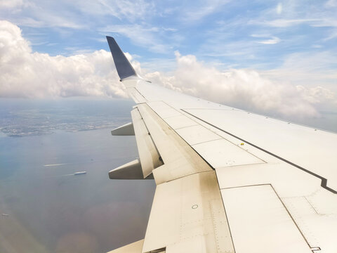 Scenic views from an airplane window, featuring blue skies, expanding clouds, landing on the runway, and mid-flight moments.