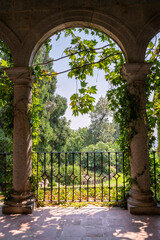 Naklejka premium Stone archway overlooking monastery garden