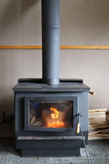 Naklejka premium Cozy fire burning in a black wood stove