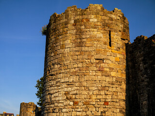 Ancient stone, Town Walls, lit by evening sun, Caernarfon, Wales, UK. © Cavan