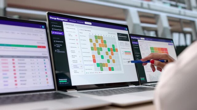 IT Manager Reviews Change Request Workflow On Laptop