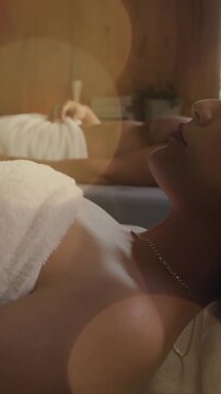 Relaxing in spa, people lying on beds with bokeh lights animation