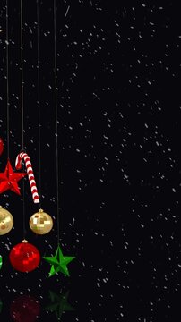 Animation of baubles christmas tree with snow falling on black background